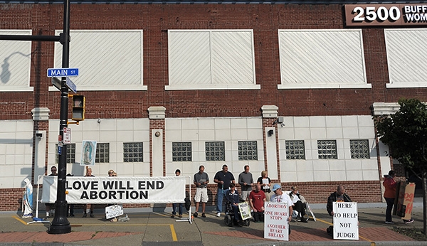 Respect Life Sidewalk advocates protest outside the Woman's Clinic on Main Street. (Dan Cappellazzo/Staff Photographer)